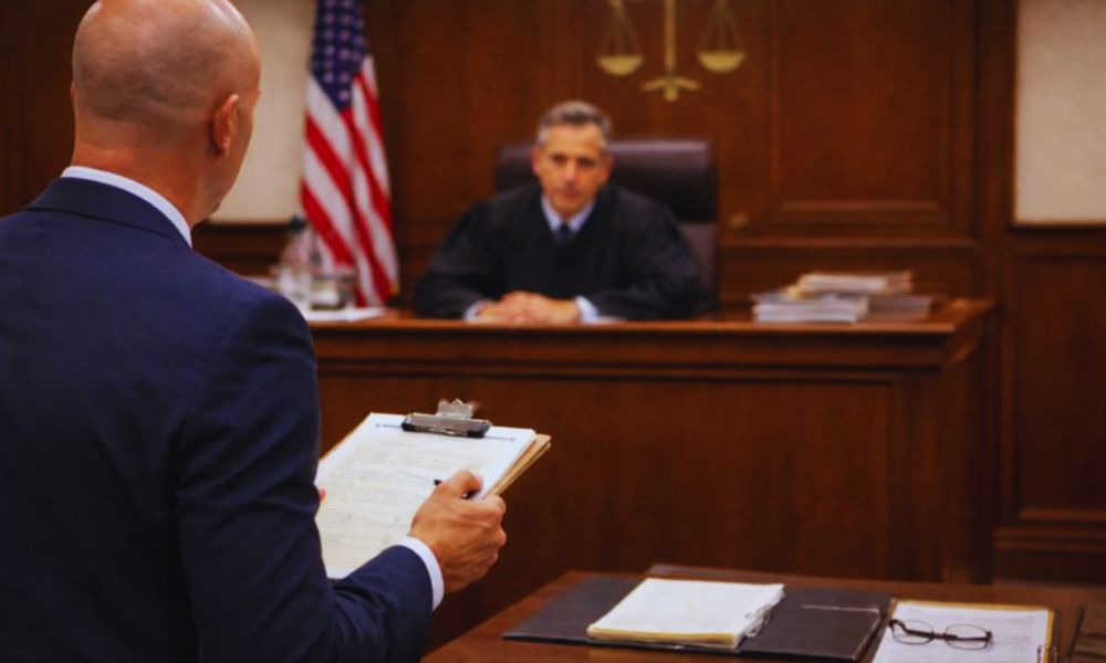 An attorney speaking to an administrative law judge during an in-person Social Security disability hearing.