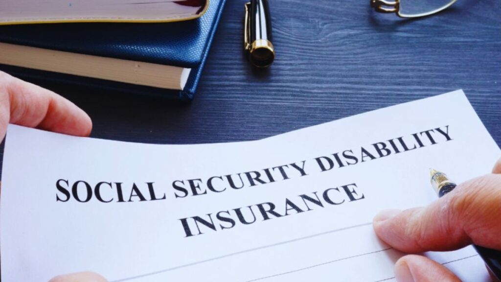 Hands holding a document titled “Social Security Disability Insurance” on a desk with legal books and a pen, representing professional Social Security Disability Insurance Representation in Miami.